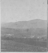 SA0251 - A view from the southeast, showing the landscape and community. Identified on the back. Ads for other views in the series are also on the back. Photo associated with the Center Family.